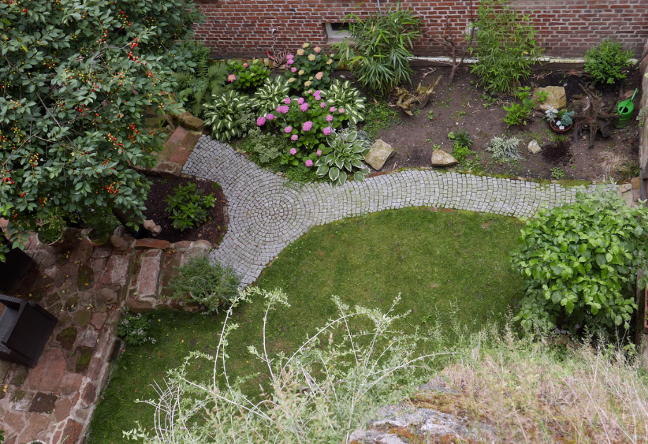 aerial view of backyard with paved path
